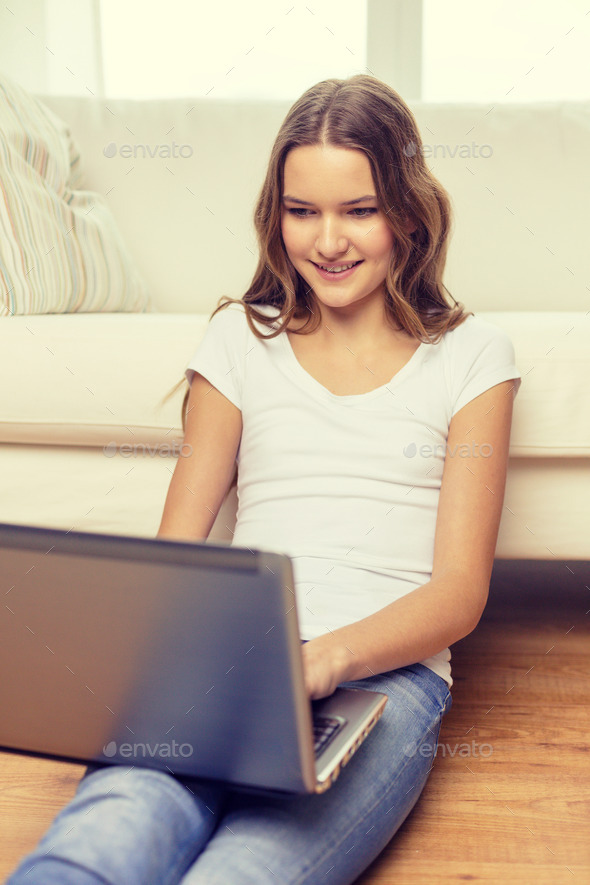 smiling teenage girl with laptop computer at home (Misc) Photo Download