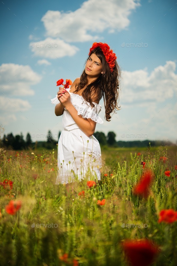 Beautiful young brunette girl wearing white summer dress and flower chaplet in poppy filed (Misc) Photo Download