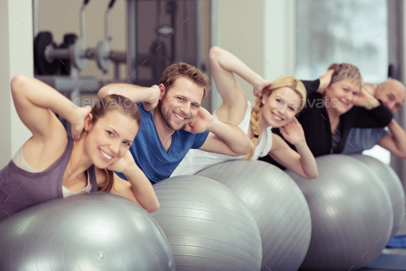 Group of people doing pilates exercises