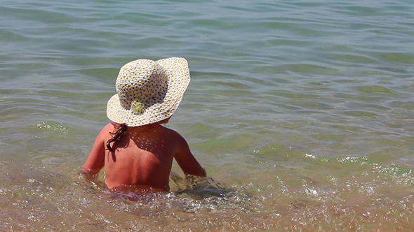 VideoHive Little Girl Sitting In Sea Waves 10103397 VideoHive Little Girl Sitting In Sea Waves 10103397