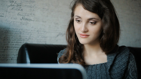 Attractive Woman Working At Home On A Laptop Attractive Woman Working At Home On A Laptop