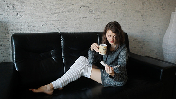 VideoHive Young Woman Reading Book And Drinking Coffee 10116240 VideoHive Young Woman Reading Book And Drinking Coffee 10116240
