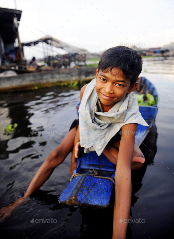 Boy Traveling by Boat in Floating Village (Misc) Photo Download