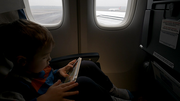 VideoHive Boy Using Tablet Pc In Plane Going To Take Off 10119296 VideoHive Boy Using Tablet Pc In Plane Going To Take Off 10119296