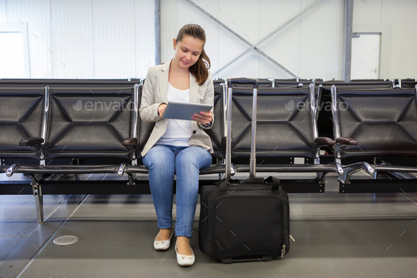 Businesswoman Using Digital Tablet At Airport Lobby