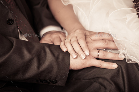 bride and groom to hold hands. loving care. retro photo