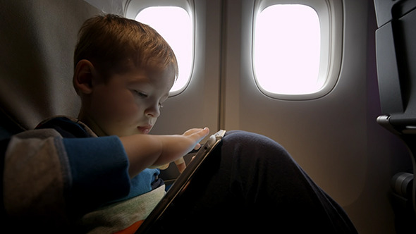 VideoHive Little Boy Playing On Touch Pad In The Plane 10133445 VideoHive Little Boy Playing On Touch Pad In The Plane 10133445