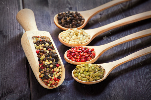 Mixed peppercorns in a wooden spoon