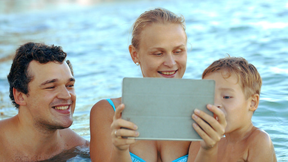 VideoHive Family Of Three In Sea Watching Something On Pad 10143701 VideoHive Family Of Three In Sea Watching Something On Pad 10143701