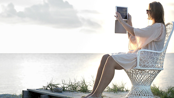 VideoHive Woman Near The Sea Making Photos Using Pad 10147968 VideoHive Woman Near The Sea Making Photos Using Pad 10147968