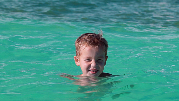 VideoHive Little Boy Bathing In Clear Blue Sea 10150203 VideoHive Little Boy Bathing In Clear Blue Sea 10150203