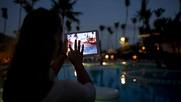 Woman Using Pad To Take Photos On Tropical Resort Woman Using Pad To Take Photos On Tropical Resort