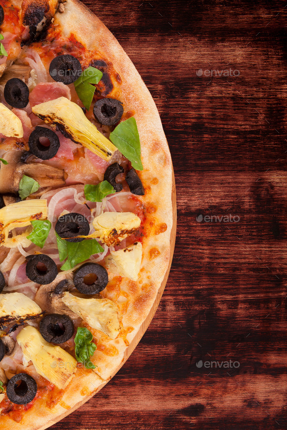 Colorful pizza on dark wooden background.