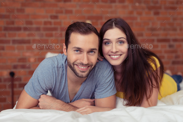 Happy couple relaxing on a bed