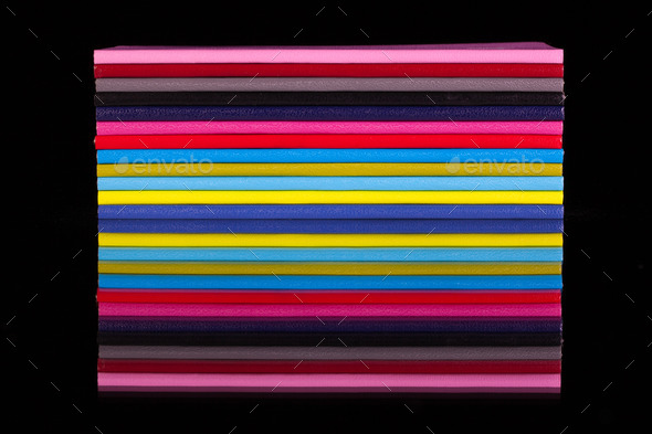 Twelve different color diaries on a black glass table (Misc) Photo Download