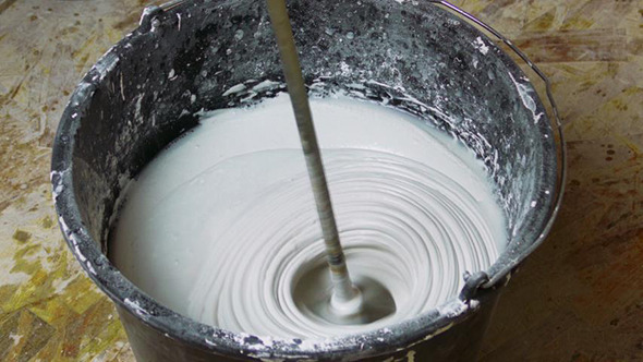 Rotating Whisk Mixer Immersed in Plaster Mix Rotating Whisk Mixer Immersed in Plaster Mix