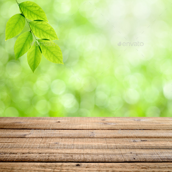 Old wooden table with green nature background - Stock Photo - Images