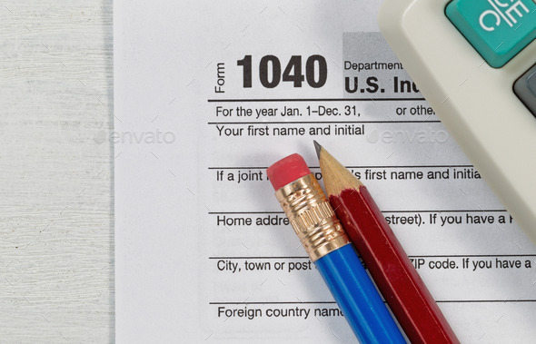 Close up of Tax Form with business objects on top