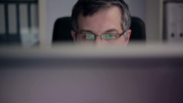 Businessman Works in front of his Computer Businessman Works in front of his Computer