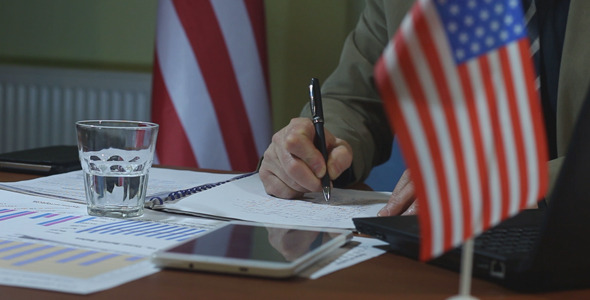 American Businessman Fills the Document American Businessman Fills the Document
