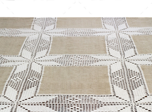 A fragment of a table covered with a linen tablecloth, decorated with lace. (Misc) Photo Download