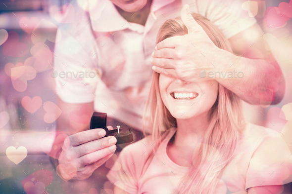 Man about to propose to his girlfriend on the sofa in sitting room at home (Misc) Photo Download