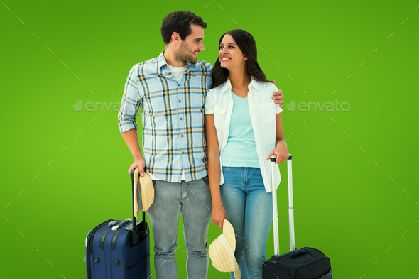 Attractive young couple going on their holidays against green vignette (Misc) Photo Download