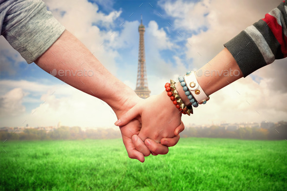 Students holding hands against eiffel tower (Misc) Photo Download