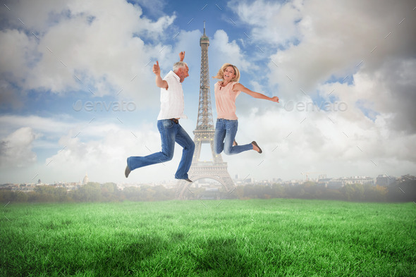 Excited couple cheering and jumping against eiffel tower (Misc) Photo Download