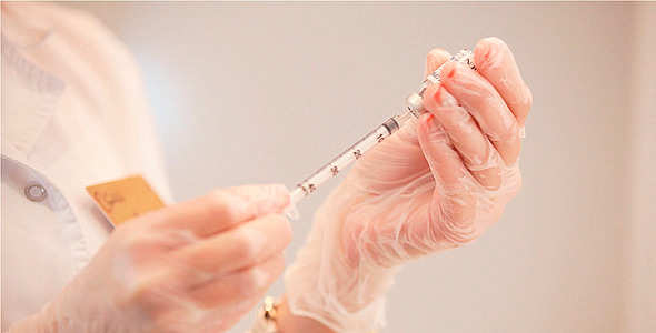Medical Doctor Gaining Medicine into the Syringe Medical Doctor Gaining Medicine into the Syringe