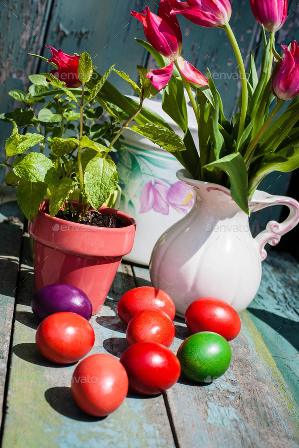 Easter table with painted eggs and tulips