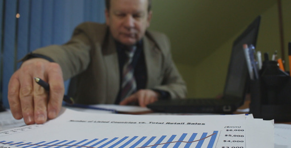 Businessman Working with Charts Businessman Working with Charts