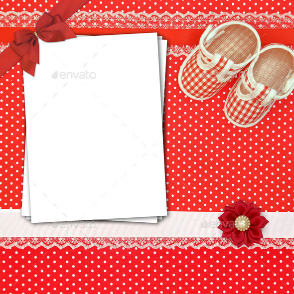 Baby shoes and paper cards on polka dots background