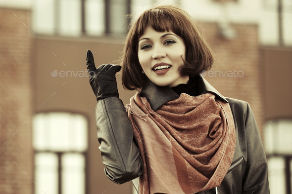 Happy young fashion woman on the autumn city street