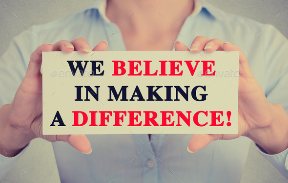 Businesswoman hands sign with We Believe in Making a Difference message