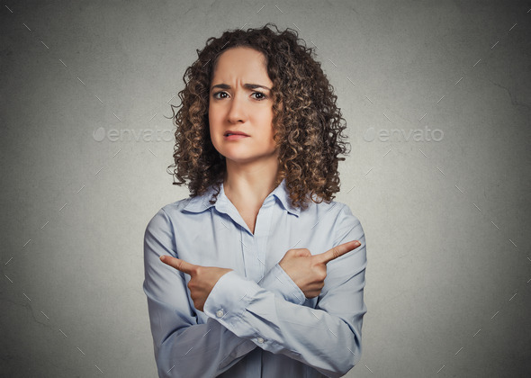 confused young woman pointing in two different directions