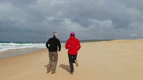 Middle-aged Couple Jogging on Beach Middle-aged Couple Jogging on Beach