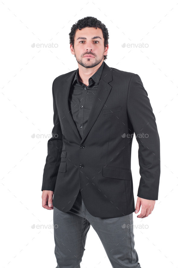 Young man in black jacket poses at studio