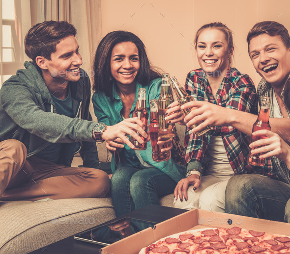 Group of multi-ethnic friends with pizza and bottles of drinks having party (Misc) Photo Download