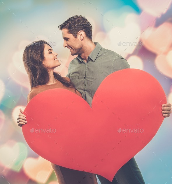 Happy couple holding handmade paper heart (Misc) Photo Download