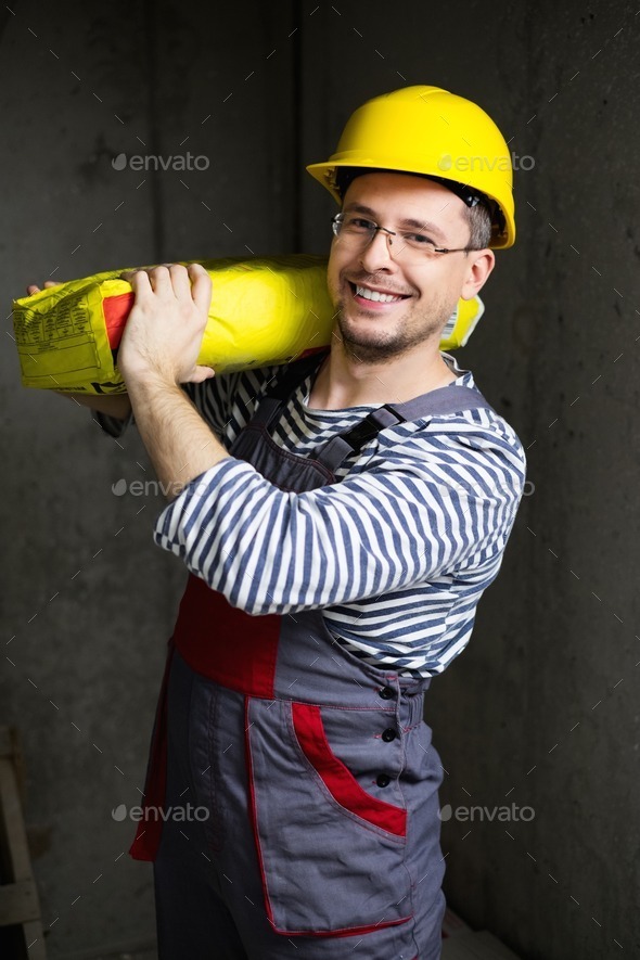 Builder carry bag with cement on his shoulder (Misc) Photo Download