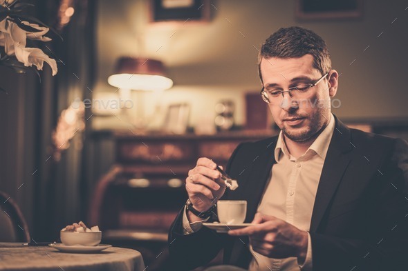 Middle-aged with cup of coffee in luxury vintage style interior (Misc) Photo Download