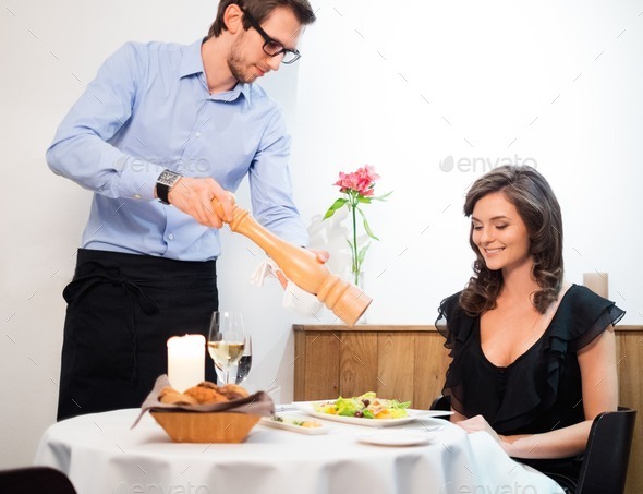 Beautiful young lady and waiter in restaurant (Misc) Photo Download