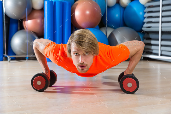 Blond man gym push-up pushup dumbbells