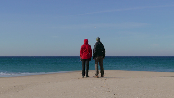 Happy Middle-aged Couple Walking on Beach Happy Middle-aged Couple Walking on Beach