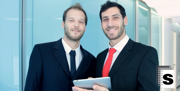 Two Businessman Working With Tablet And Smile Two Businessman Working With Tablet And Smile