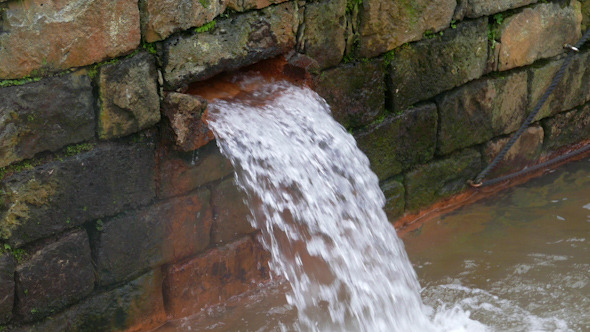 Hot Spring Water Flow from Pipe on Wall Hot Spring Water Flow from Pipe on Wall