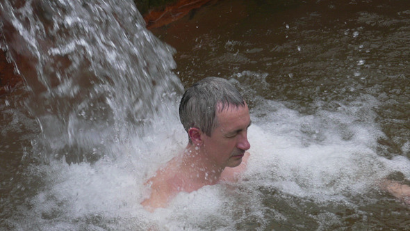 Man Taking Bath in Hot Springs Man Taking Bath in Hot Springs
