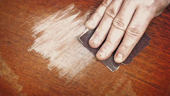 Hand Sanding A Wooden Surface Hand Sanding A Wooden Surface