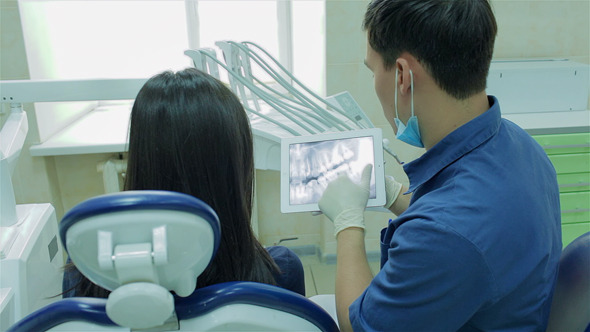 Dentist Shows At Tablet Image Of Healthy Teeth Dentist Shows At Tablet Image Of Healthy Teeth
